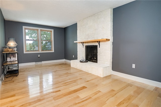 unfurnished living room with light hardwood / wood-style floors and a fireplace