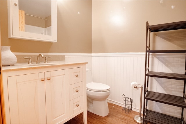 bathroom featuring vanity, toilet, and hardwood / wood-style floors