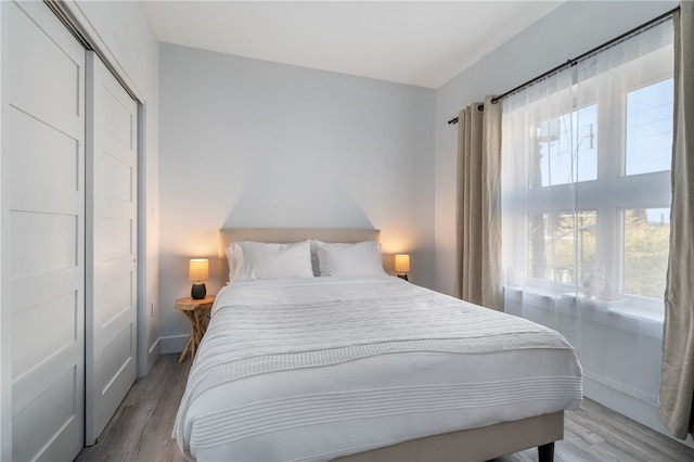 bedroom with a closet and light hardwood / wood-style floors