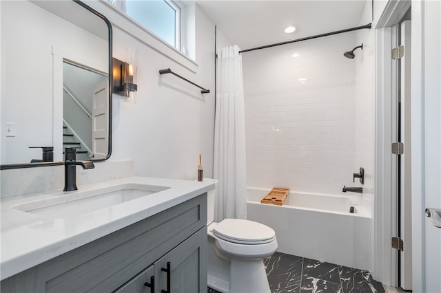 full bathroom featuring shower / bath combo with shower curtain, vanity, and toilet