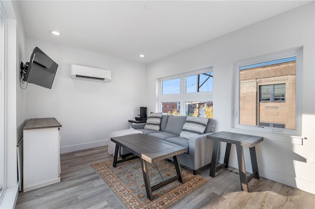 living room with an AC wall unit and wood-type flooring