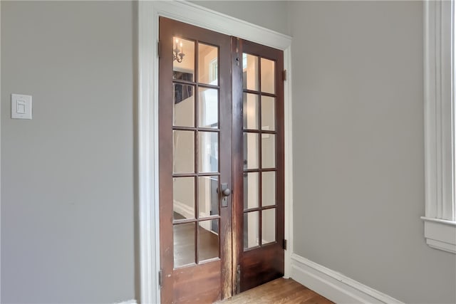 interior details featuring french doors and hardwood / wood-style flooring