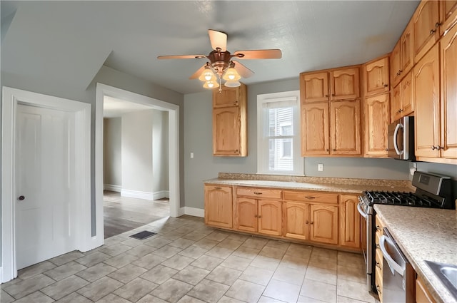 kitchen with ceiling fan and appliances with stainless steel finishes