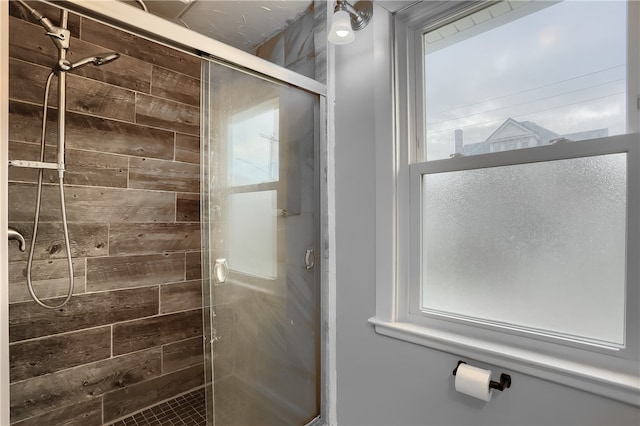 bathroom featuring a shower with shower door