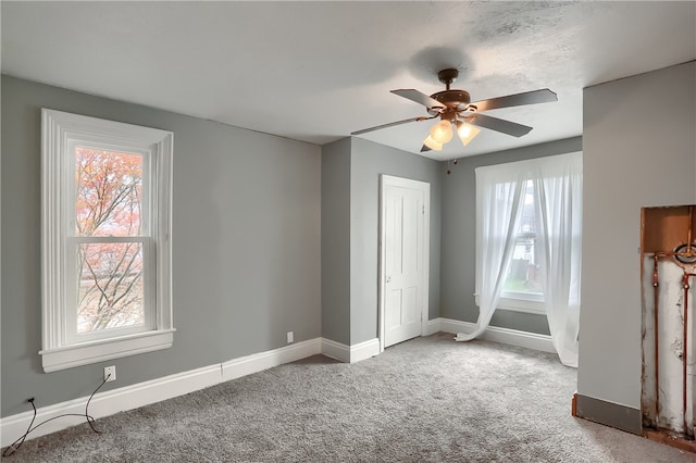 unfurnished bedroom featuring ceiling fan, a closet, and carpet floors