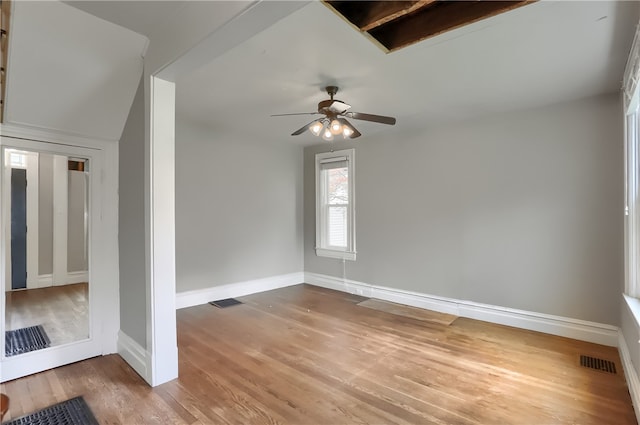 spare room with ceiling fan and hardwood / wood-style flooring