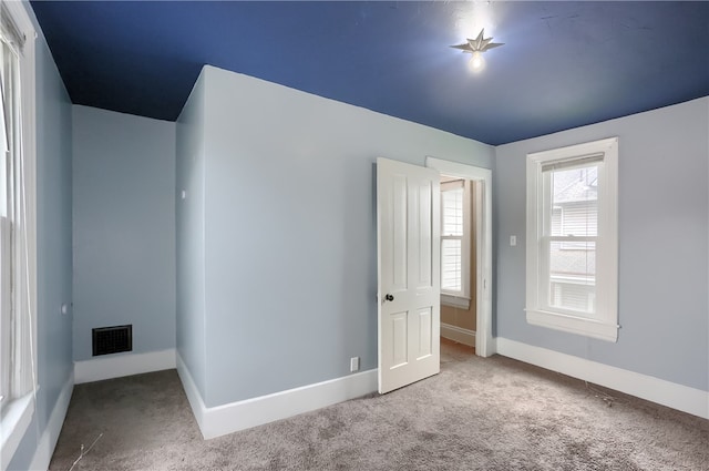 unfurnished bedroom with light colored carpet