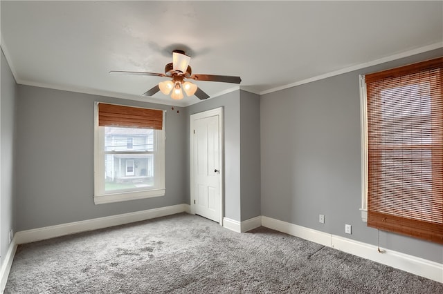 unfurnished bedroom featuring ceiling fan, crown molding, and light colored carpet