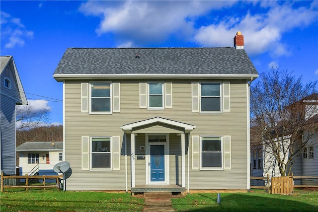 colonial house featuring a front yard