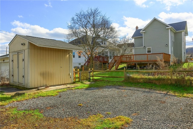 view of yard featuring an outbuilding and a wooden deck