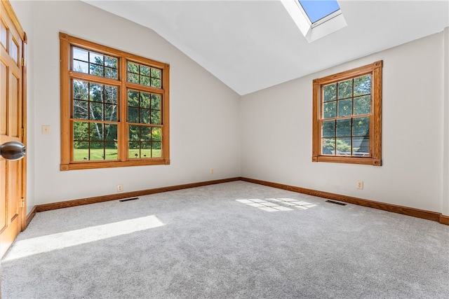 spare room with carpet and lofted ceiling with skylight