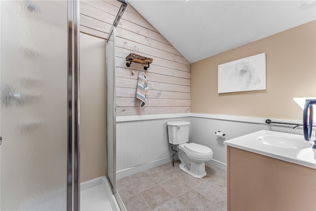 bathroom featuring vanity, toilet, wooden walls, a shower with shower door, and vaulted ceiling