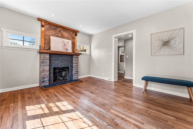 unfurnished living room with hardwood / wood-style flooring and a fireplace