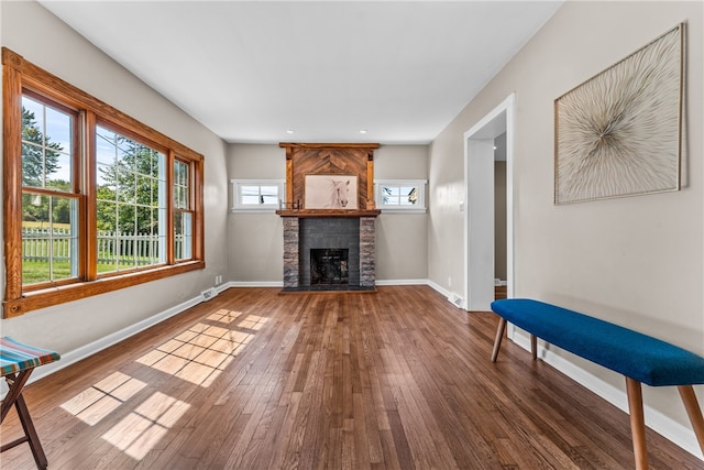 unfurnished living room featuring a fireplace and dark hardwood / wood-style floors