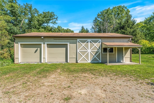 garage featuring a lawn