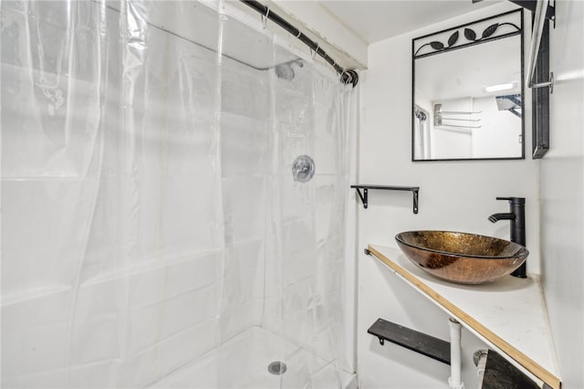 bathroom with walk in shower and sink