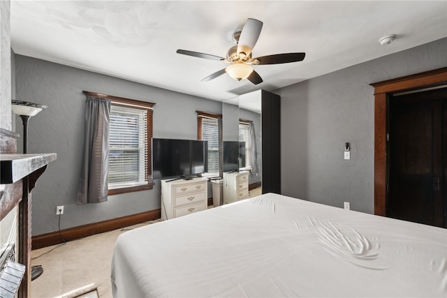 bedroom featuring light colored carpet and ceiling fan