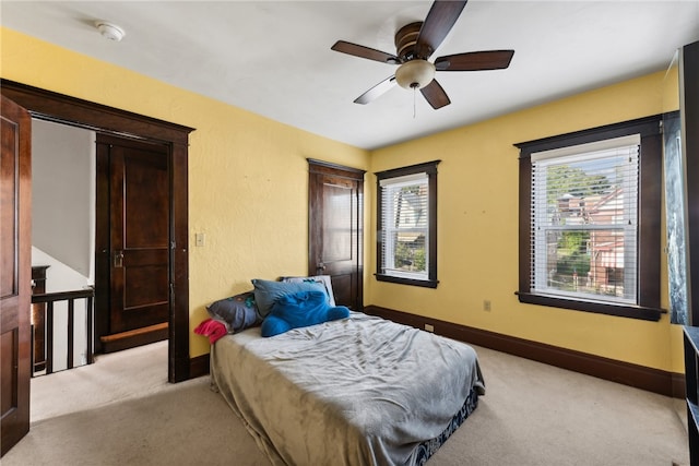 carpeted bedroom with ceiling fan