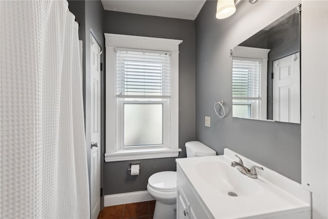 bathroom featuring vanity, toilet, and tile patterned flooring