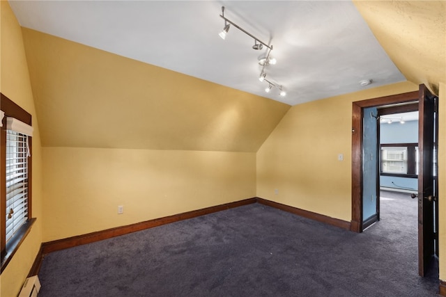 bonus room featuring dark carpet, a baseboard radiator, and vaulted ceiling