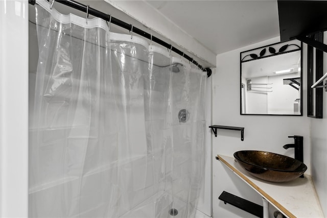 bathroom with a shower with curtain and sink