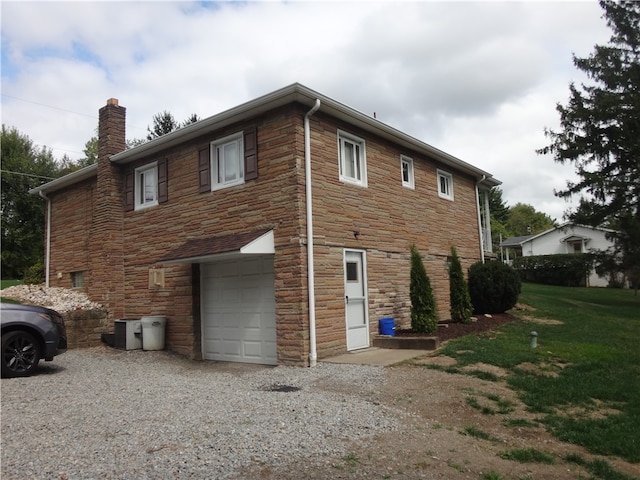 view of property exterior featuring a yard and a garage