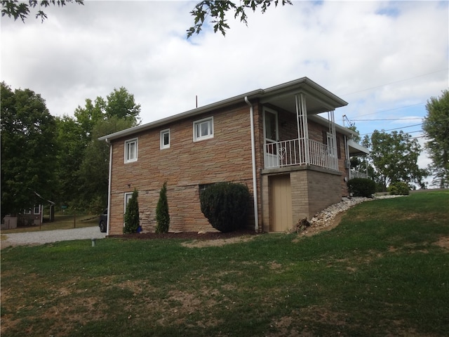 view of side of home with a yard