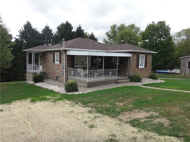 ranch-style home with a front yard and a porch