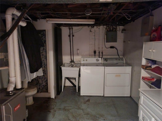 clothes washing area with washing machine and clothes dryer and electric panel