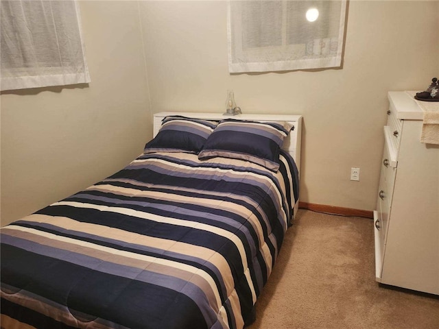 bedroom featuring light carpet