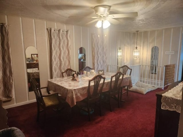 carpeted dining area featuring a textured ceiling and ceiling fan