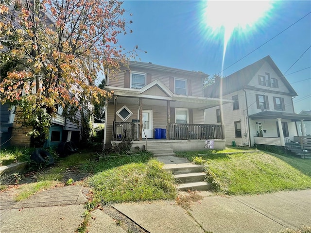 view of front of house featuring a front yard and covered porch