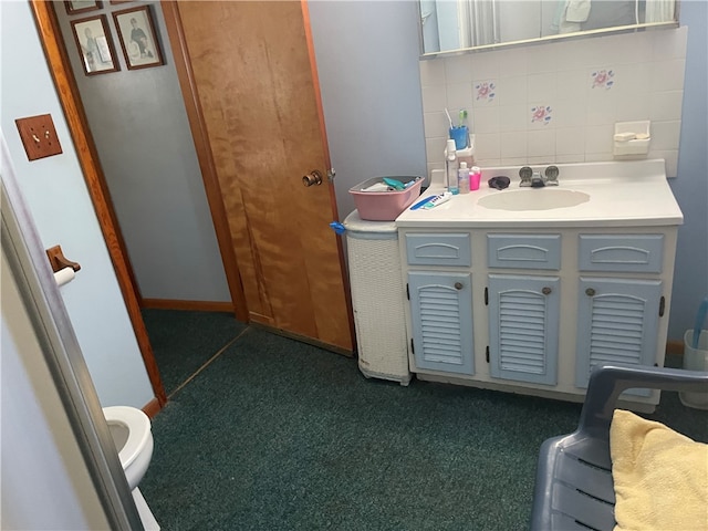 bathroom with decorative backsplash, vanity, and toilet