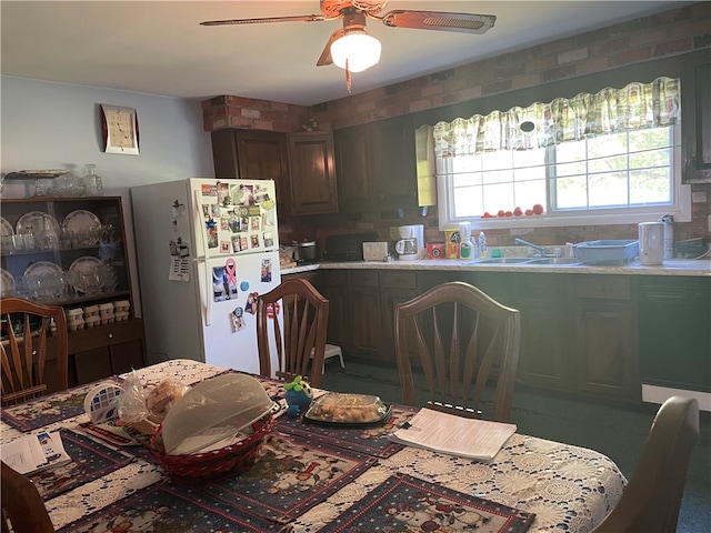 kitchen featuring ceiling fan, white refrigerator, and sink