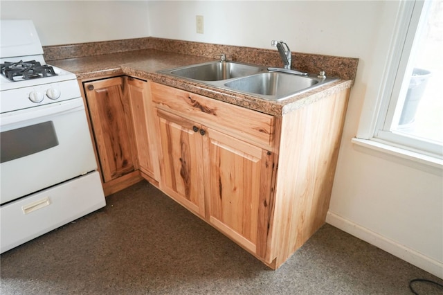 kitchen featuring white gas range and sink