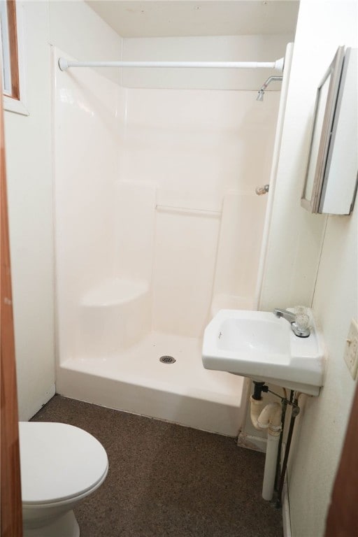 bathroom with toilet and walk in shower