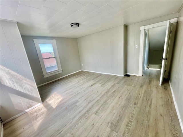 spare room with light hardwood / wood-style flooring