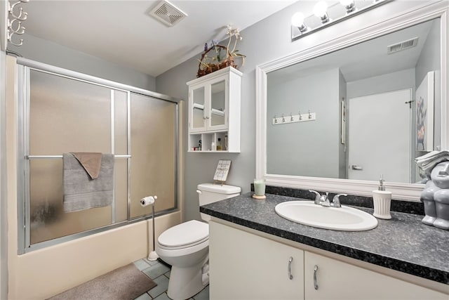 full bathroom featuring tile patterned floors, bath / shower combo with glass door, vanity, and toilet