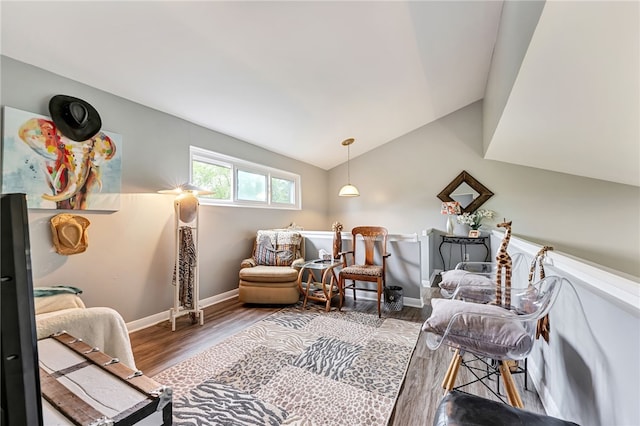 living area featuring vaulted ceiling and hardwood / wood-style flooring