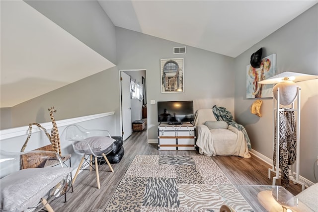 living area with wood-type flooring and vaulted ceiling