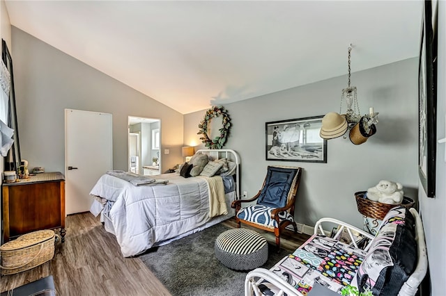 bedroom featuring lofted ceiling and dark hardwood / wood-style floors