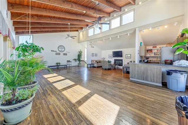 interior space featuring high vaulted ceiling, ceiling fan, and dark wood-type flooring