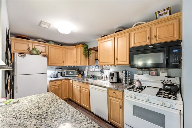 kitchen featuring dark wood-type flooring, white appliances, light stone countertops, light brown cabinets, and sink