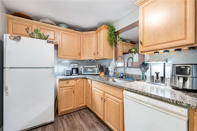 kitchen with light stone counters, dark hardwood / wood-style floors, sink, white appliances, and light brown cabinets