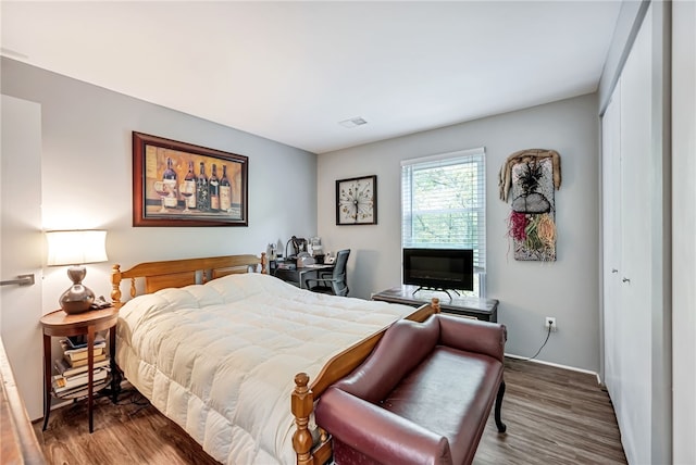 bedroom with a closet and dark hardwood / wood-style floors