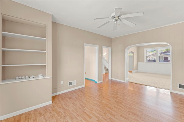 interior space with light wood-type flooring, crown molding, and ceiling fan