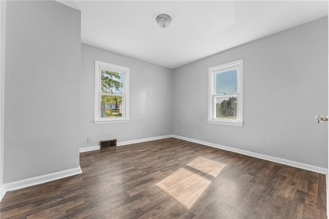 empty room with dark wood-type flooring