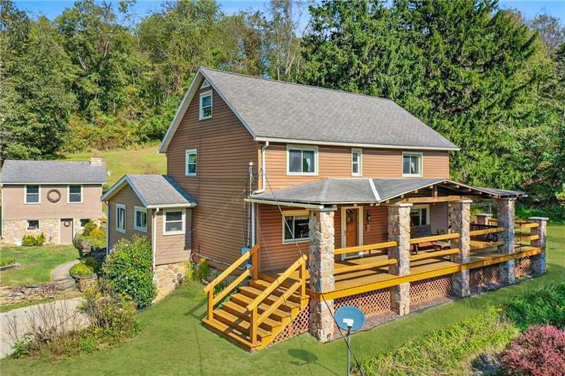 rear view of house with a deck and a yard