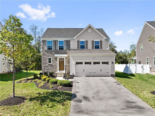 view of front of property with a garage and a front lawn