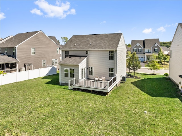 back of house featuring a wooden deck, central AC, and a yard